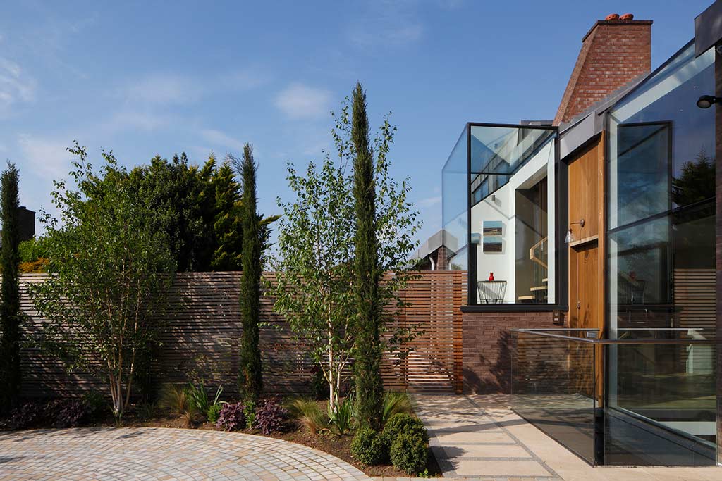 An example of one of Canmore Construction Scotland Limited's projects - a luxury residential renovation, with full height glass extensions and a beautifully landscaped garden